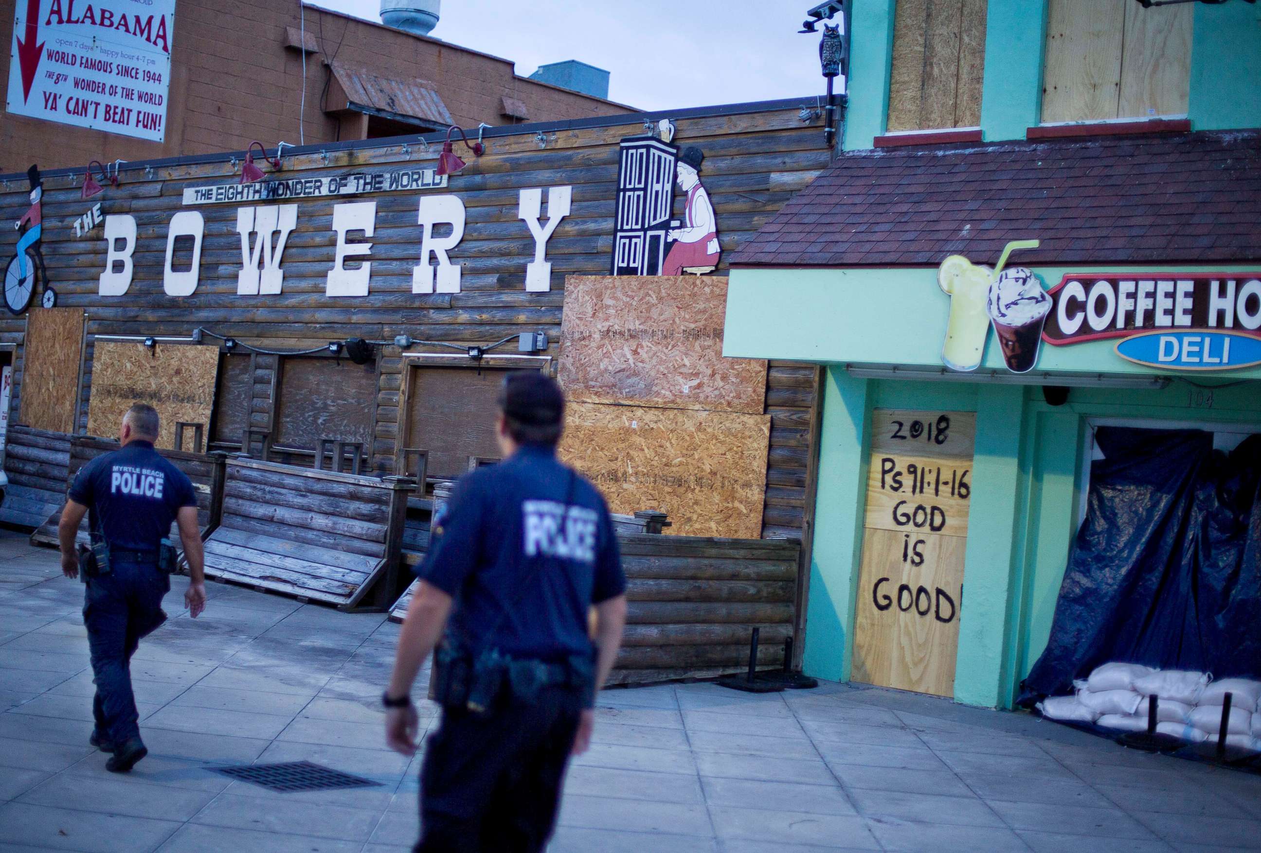 PHOTO: Police patrol past boarded up shops along the boardwalk in Myrtle Beach, S.C., Thursday, Sept. 13, 2018, as Hurricane Florence approaches the east coast.