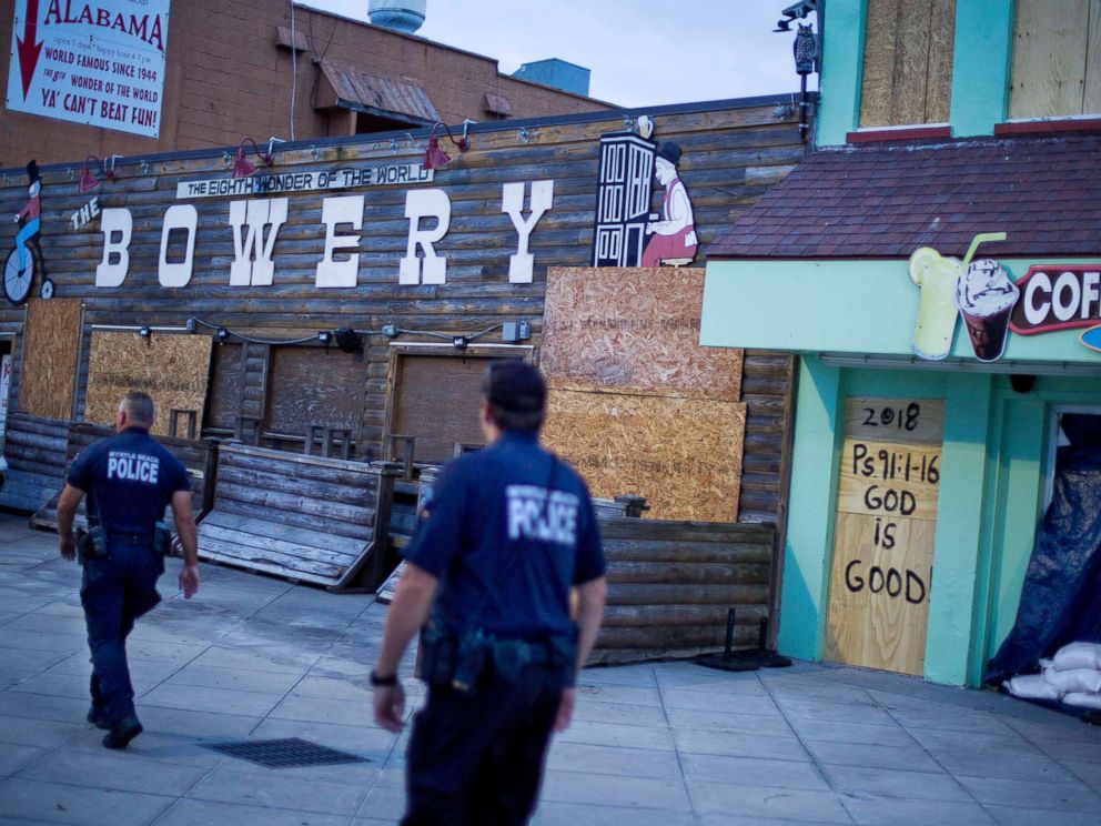 PHOTO: Police patrol past boarded up shops along the boardwalk in Myrtle Beach, S.C., Thursday, Sept. 13, 2018, as Hurricane Florence approaches the east coast.