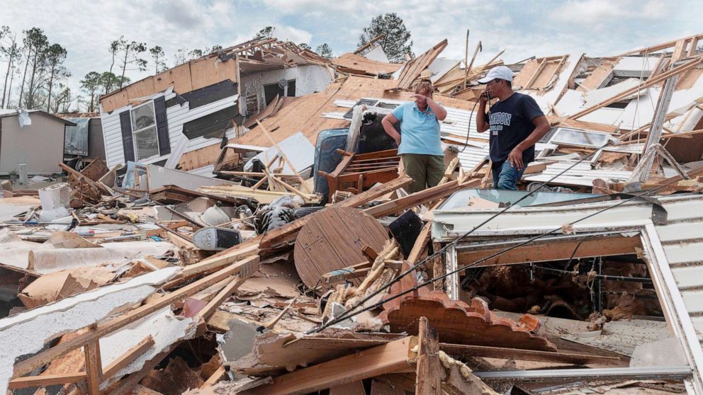 PHOTO: A couple react as they go through their destroyed mobile home following the passing of hurricane Laura in Lake Charles, La., on Aug. 27, 2020.