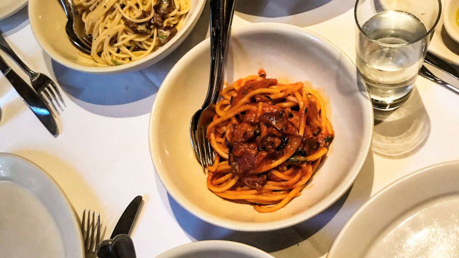 PHOTO: Bucatini all'Amatriciana seen plated in the middle of the table.