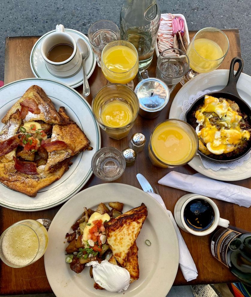 PHOTO: A full table of brunch dishes including Croque Madame and corned beef hash. 