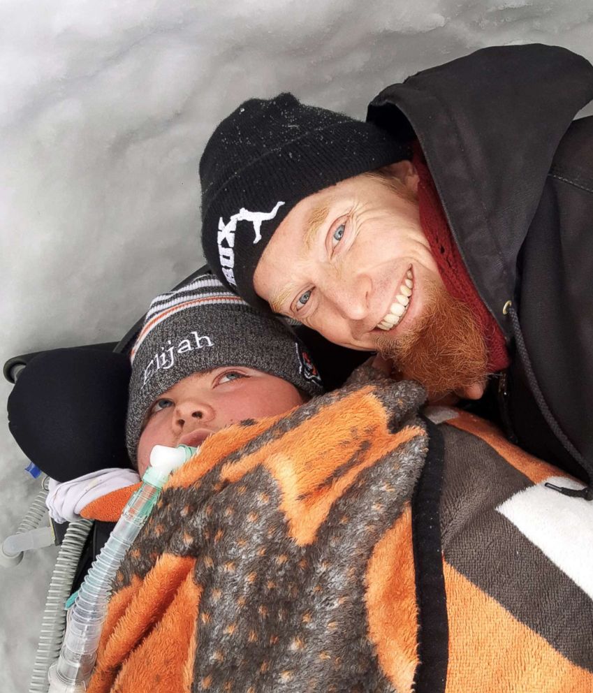 PHOTO: Gregg Eichhorn poses with his son, Elijah, in a snow fort in the family's backyard.