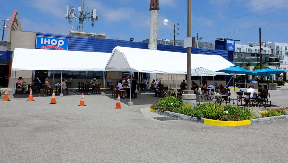 PHOTO: Customers dine al fresco in the reconfigured parking lot of IHOP on July 19, 2020, in Marina del Rey, Calif.