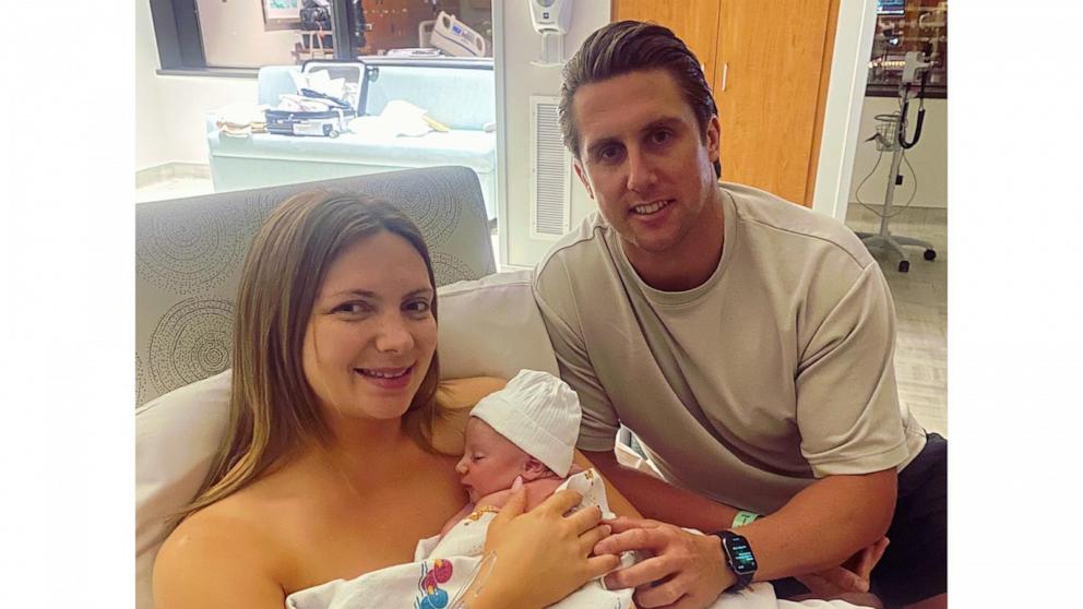 PHOTO: Maisie Savage and Josh French with their son Theo.