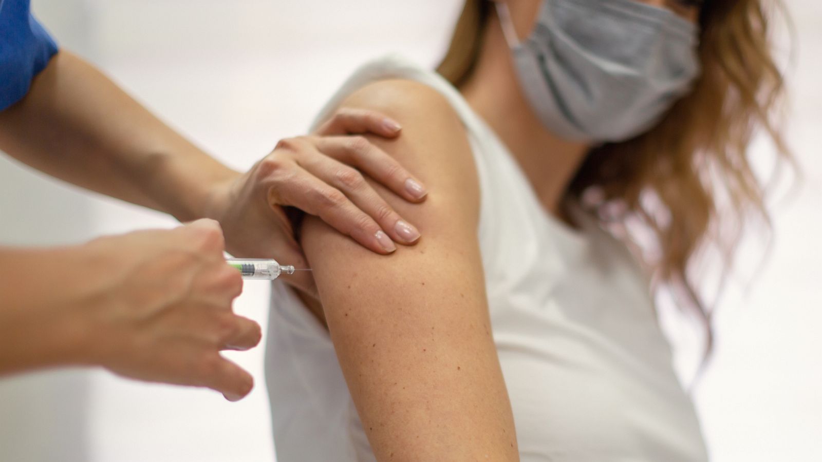 PHOTO: A COVID-19 vaccine is being administered to a woman by a medical professional in this stock image.