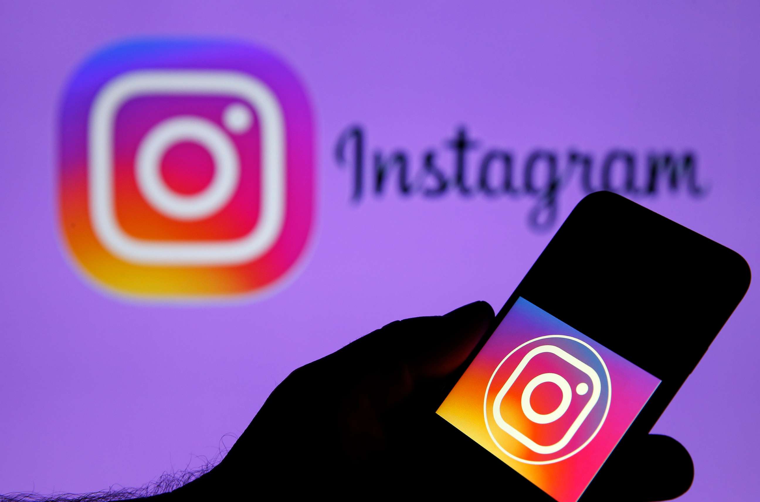 PHOTO: In this photo illustration, the Instagram logo is displayed on the screen of an iPhone in front of a TV screen displaying the Instagram logo on Dec. 10, 2019 in Paris.