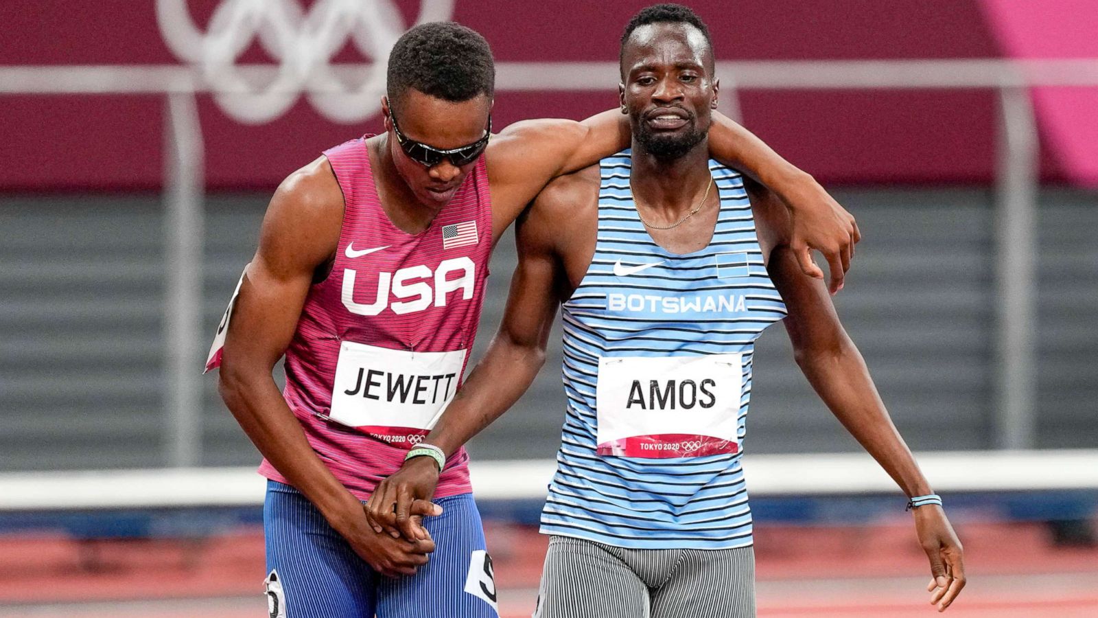 PHOTO: Isaiah Jewett, of the United States, and Nijel Amos, right, of Botswana, shake hands after falling in the men's 800-meter semifinal at the 2020 Summer Olympics, Aug. 1, 2021, in Tokyo.