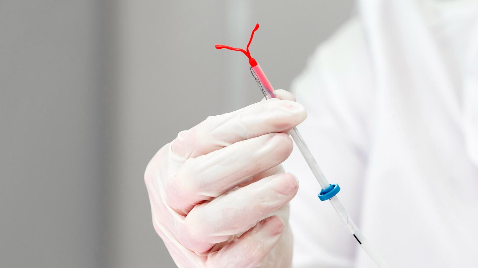 PHOTO: Stock photo of a doctor holding an IUD device.