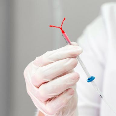 PHOTO: Stock photo of a doctor holding an IUD device.