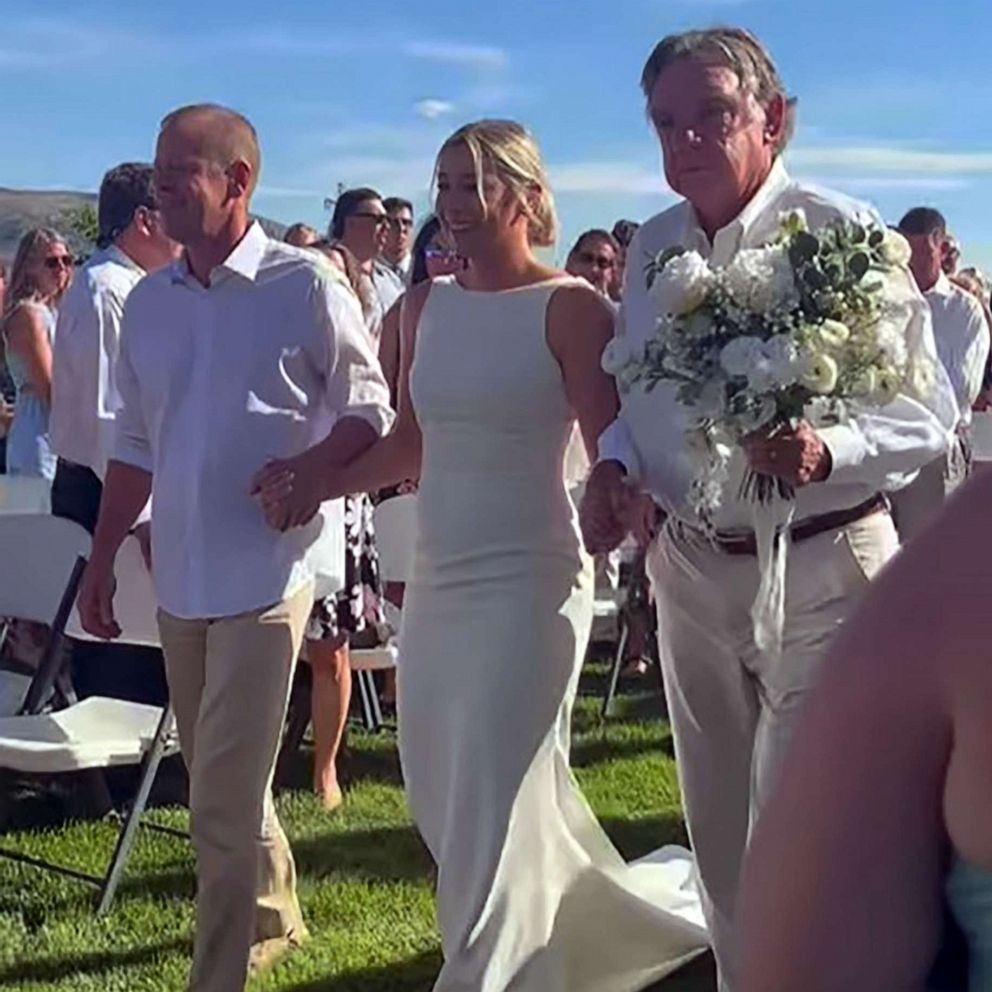 VIDEO: Bride walks down aisle with 15 important men in her life