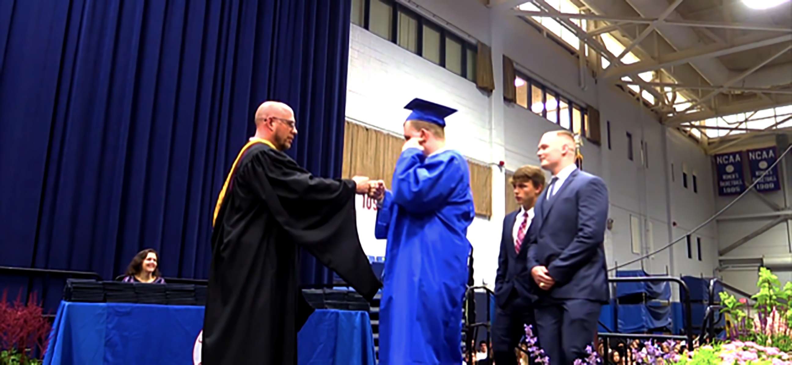 PHOTO: Jack Higgins walks up to receive his diploma from Principal Lou Riolo.