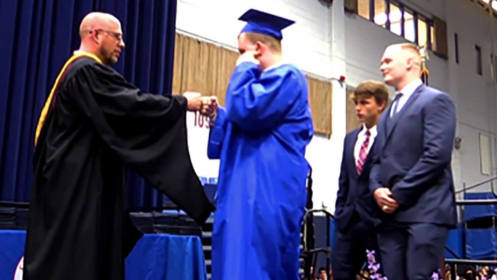 PHOTO: Jack Higgins walks up to receive his diploma from Principal Lou Riolo.