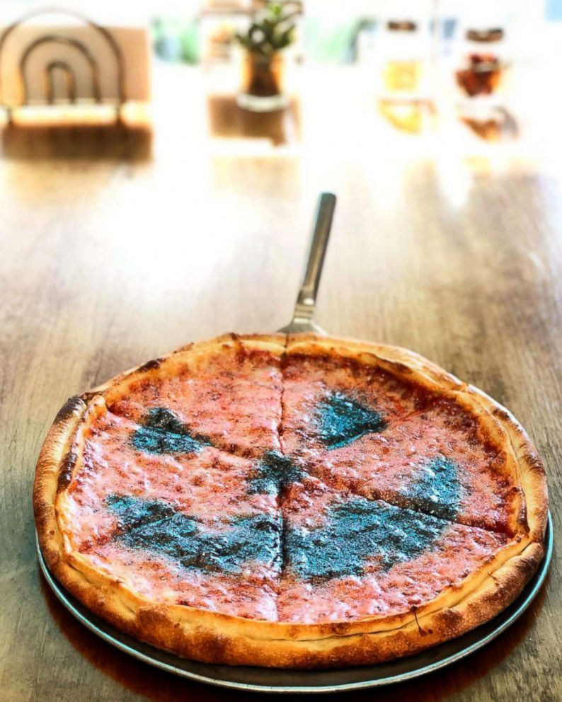 PHOTO: The sparkly, jack-o-lantern pizza is made with extra mozzarella cheese, homemade pizza sauce and dough and edible black and orange glitter.
