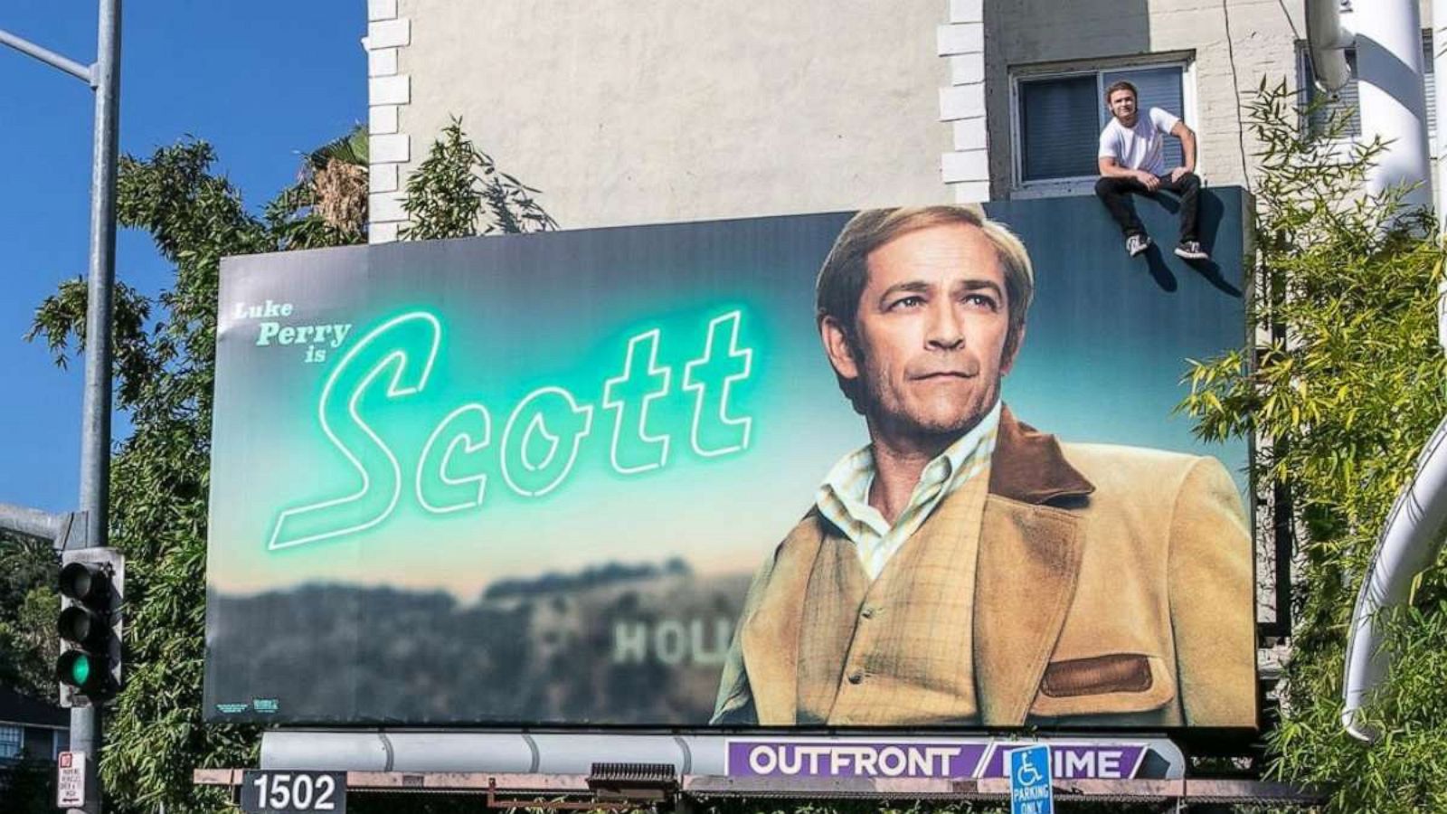 PHOTO: Jack Perry sits on top of a "Once Upon a Time in Hollywood" billboard showing his father Luke Perry.