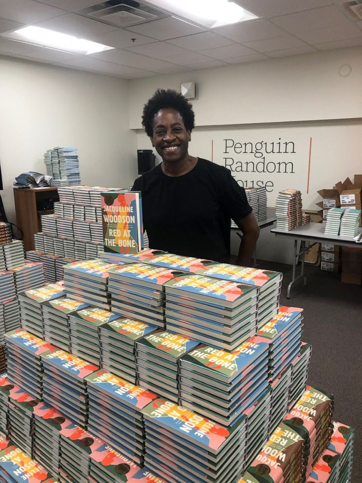 PHOTO: Author Jacqueline Woodson poses with her book, "Red at the Bone," which was challenged in various states across the U.S. amid a spike in book bans.