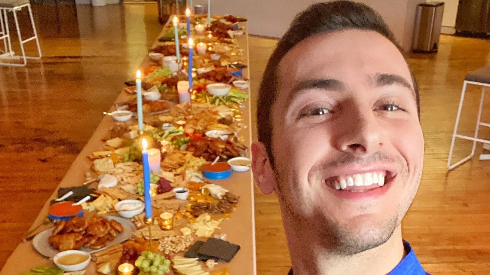 PHOTO: Jake Cohen takes a selfie with a full Hanukkah Shabbat spread.