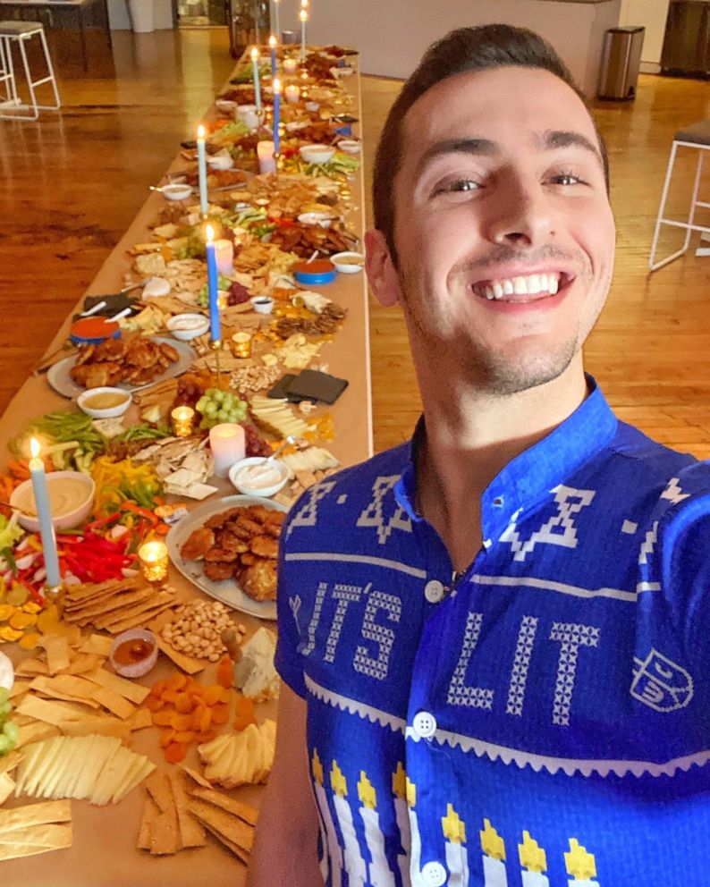 PHOTO: Jake Cohen takes a selfie with a full Hanukkah Shabbat spread.
