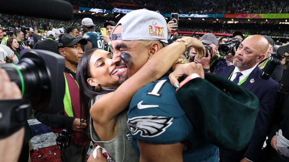 PHOTO: Jalen Hurts of the Philadelphia Eagles and fiancee, Bry Burrows, embrace after defeating the Kansas City Chiefs 40-22 to win Super Bowl LIX in New Orleans, La., Feb. 09, 2025.