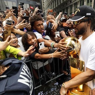 PHOTO: Jalen Brunson celebrates with the Larry O'Brien Championship Trophy during the New York Knicks Parade on June 18, 2026, in New York.