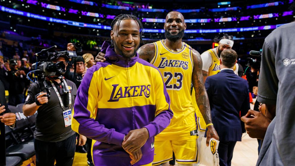 PHOTO: Los Angeles Lakers guard Bronny James (9) and Los Angeles Lakers forward LeBron James (23) leaves the court after a win over the Minnesota Timberwolves in the home opener, Oct. 22, 2024, in Los Angeles.