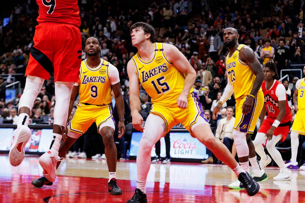 PHOTO: Bronny James #9 and LeBron James #23 of the Los Angeles Lakers defend against the Toronto Raptors during the second half of their NBA game at Scotiabank Arena, Nov. 1, 2024, in Toronto.