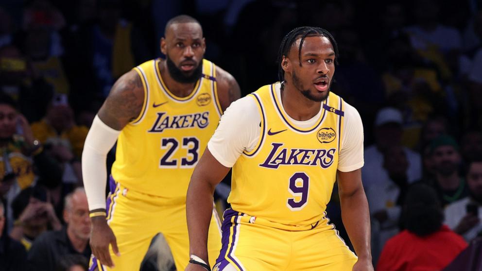 PHOTO: LeBron James #23 and Bronny James #9 of the Los Angeles Lakers on defense during the second quarter against the Minnesota Timberwolves at Crypto.com Arena on Oct. 22, 2024 in Los Angeles.