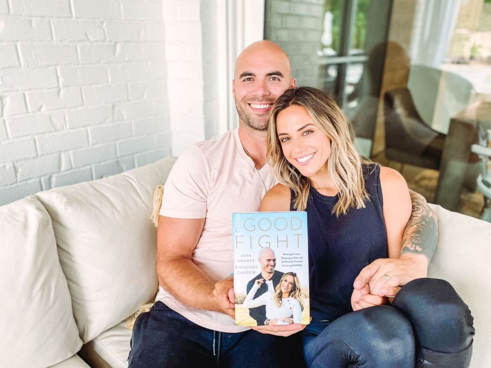 PHOTO: Jana Kramer and husband Michael Caussin are seen holding a copy of their book "The Good Fight."