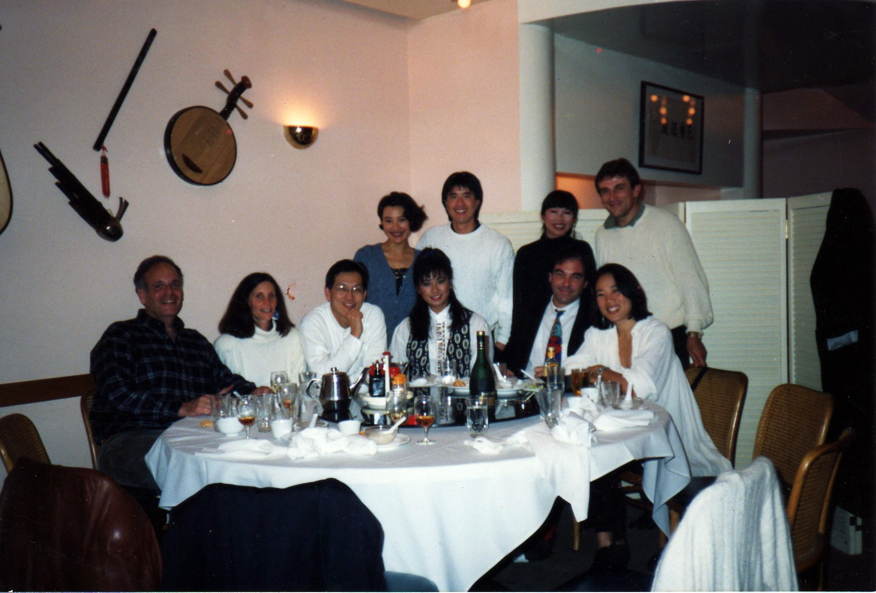 PHOTO: Janet Yang, seated on the far right, is pictured at a celebratory dinner in San Francisco with Oliver Stone, Amy Tan and Joan Chen among others.