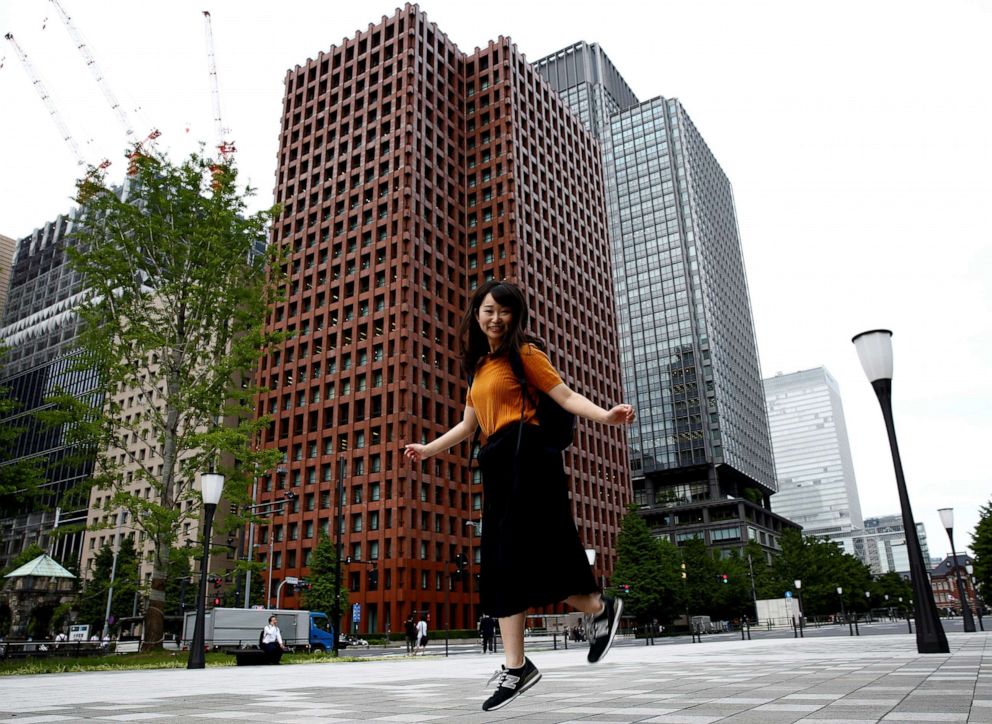 PHOTO: Yumi Ishikawa jumps as she poses in a business district during an interview with Reuters in Tokyo on June 4, 2019. 
