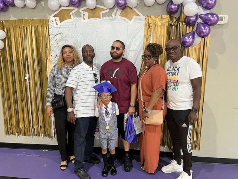 PHOTO: Jaxon Carter, 6, poses with his father and grandparents at his kindergarten graduation in June 2023.