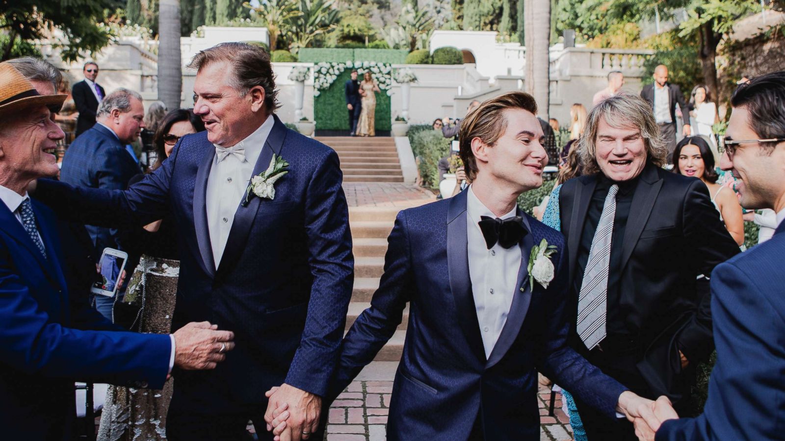 PHOTO: Jeff Rohrer, left, a former NFL player, and Joshua Ross greet guests during their wedding ceremony in Los Angeles, Nov. 18, 2018.