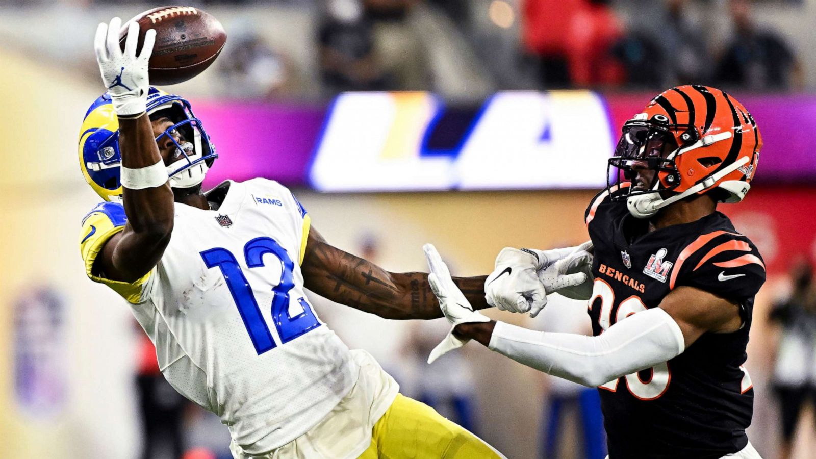 PHOTO: Los Angeles Rams wide receiver Van Jefferson tries to catch a ball while Cincinnati Bengals cornerback Eli Apple defends at Sofi Stadium, Inglewood, Calif., Feb. 13, 2022.