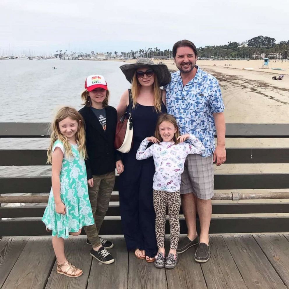 PHOTO: Jenna Karvunidis poses with her husband and their three daughters.