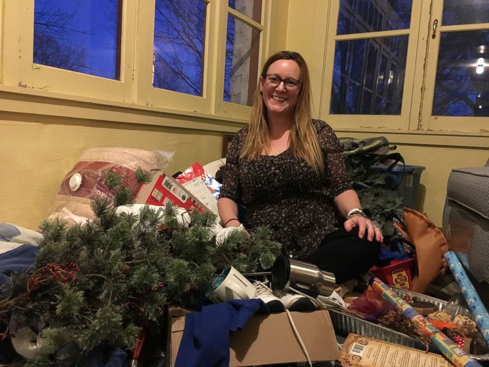 PHOTO: Jenni DeWitt sits among items she is sorting through in her Nebraska home.