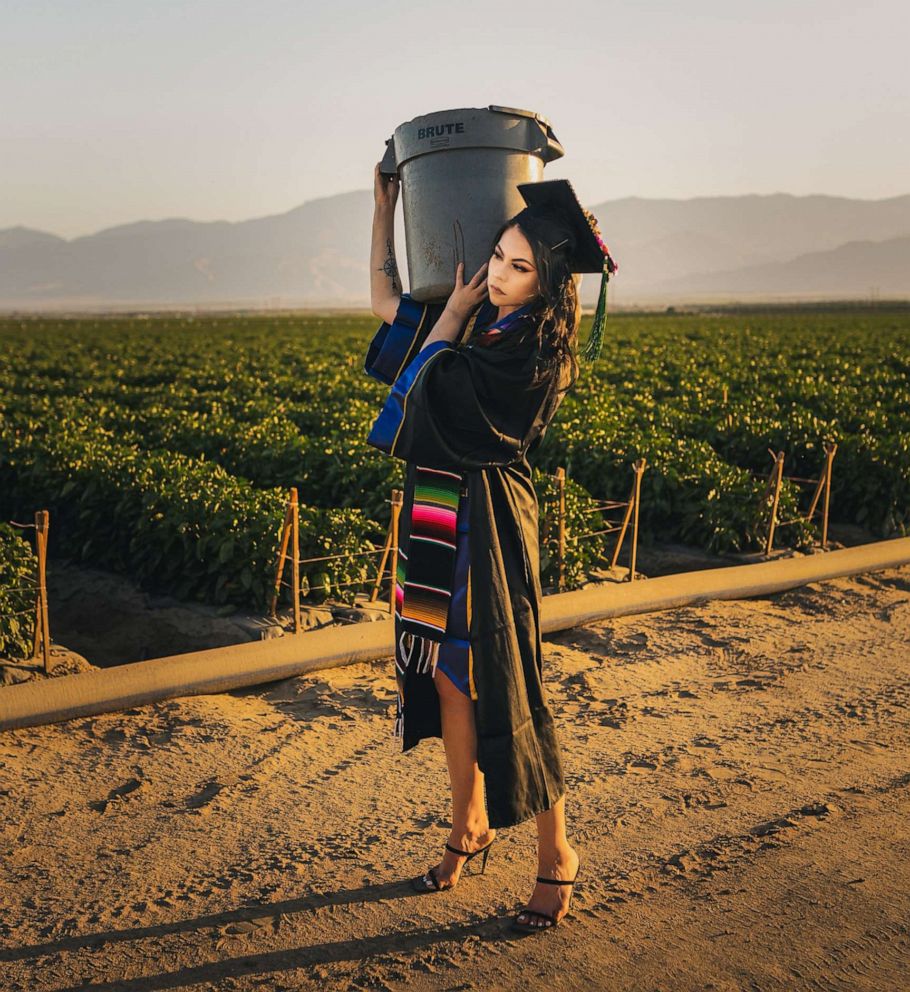 PHOTO: Jennifer Rocha, 21, a new graduate from the University of California San Diego, poses for a graduation photo in the fields where her parents worked to support her education.