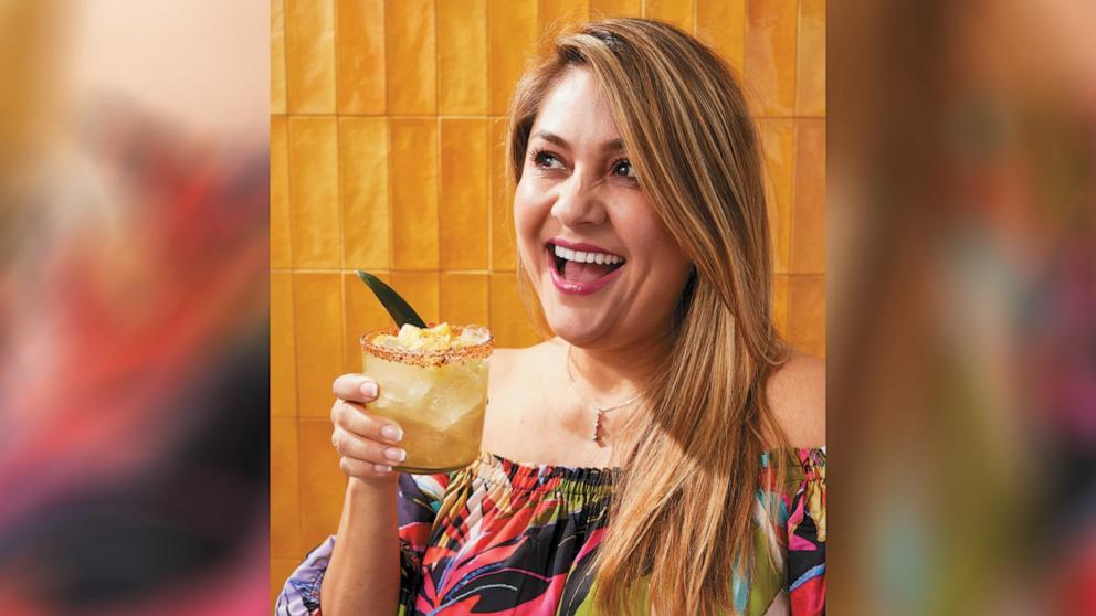 PHOTO: Jenny Martinez holds a pineapple margarita.