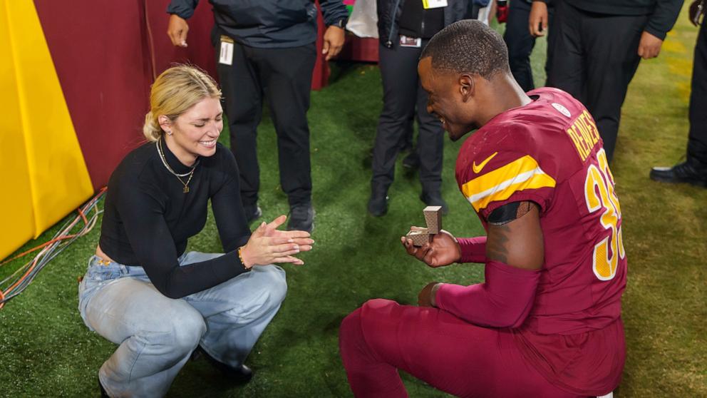 PHOTO: Mikaela Worley accepts the proposal from safety Jeremy Reaves #39 of the Washington Commanders on the field following an NFL football game against the Atlanta Falcons at Northwest Stadium in Landover, Md., Dec. 29, 2024.