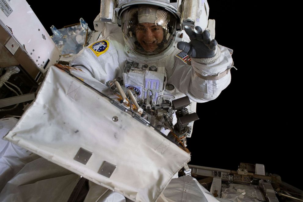 PHOTO: NASA astronaut Jessica Meir waves at the camera during a spacewalk with fellow NASA astronaut Christina Koch (out of frame).