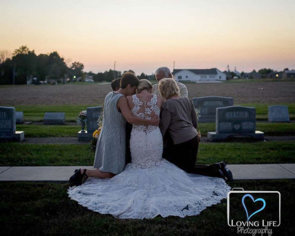 PHOTO: Jessica Padgett with her family hugging at Kendall Murphy's tombstone Providence Mennonite Church grave site, Sept. 29, 2018.