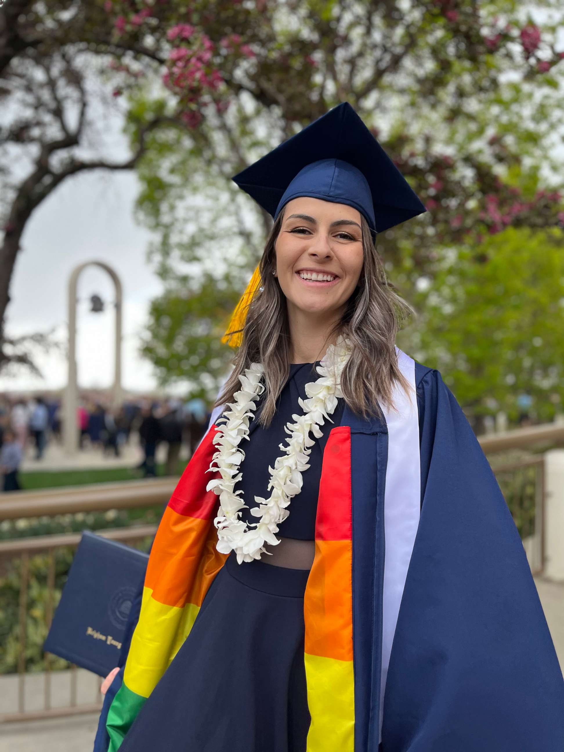PHOTO: Jillian Orr poses with her modified graduation gown. Her sister, Rachel Orr, helped her sew a gay pride flag on the inside of her gown.