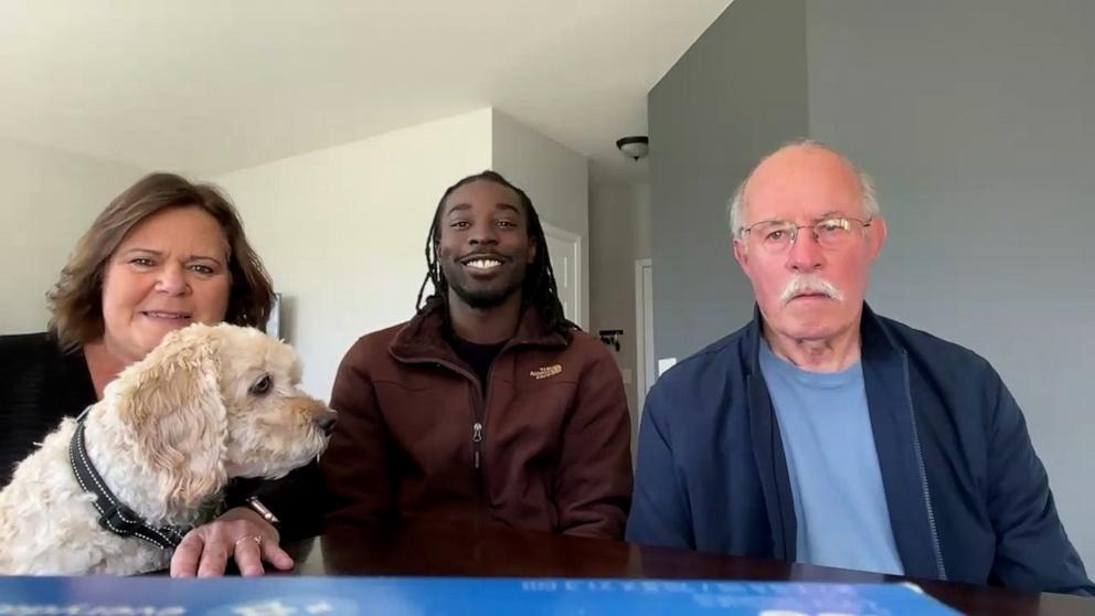 PHOTO: Marcia Miller and Guy Miller of Aurora, Illinois with mail carrier Jaylen Lockhart (center). The Millers and Lockhart plan on spending Thanksgiving together this November.