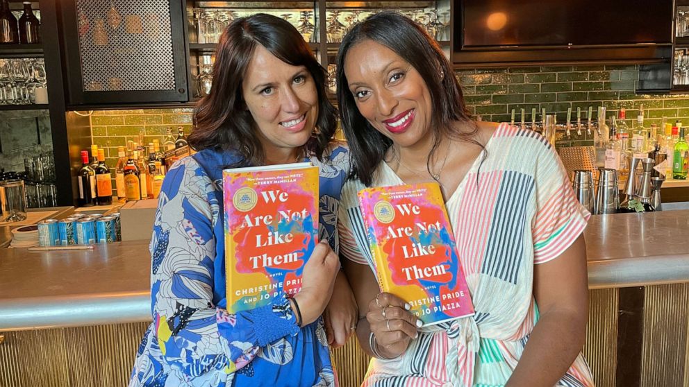 PHOTO: Authors Jo Piazza and Christine Pride pose with their book, "We Are Not Like Them."