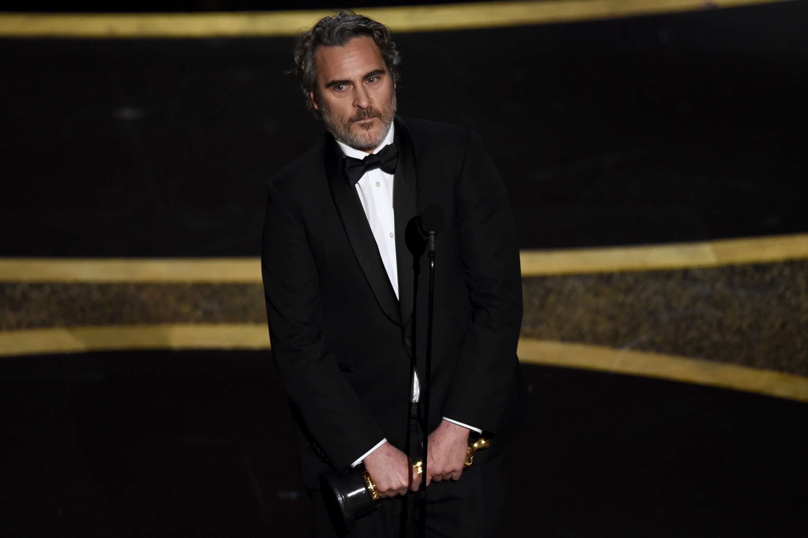 PHOTO: Joaquin Phoenix reacts as he accepts the award for best performance by an actor in a leading role for "Joker" at the Oscars, Feb. 9, 2020, at the Dolby Theatre in Los Angeles.