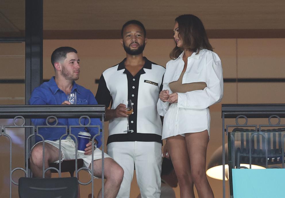 PHOTO: Nick Jonas speaks with John Legend and Chrissy Teigen as they attend the artistic gymnastics women's qualification at the 2024 Paris Olympics, July 28, 2024.