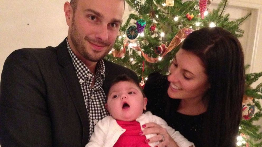 PHOTO: John and Kristen Spytek pose with their daughter Evelyn, who died in 2014.