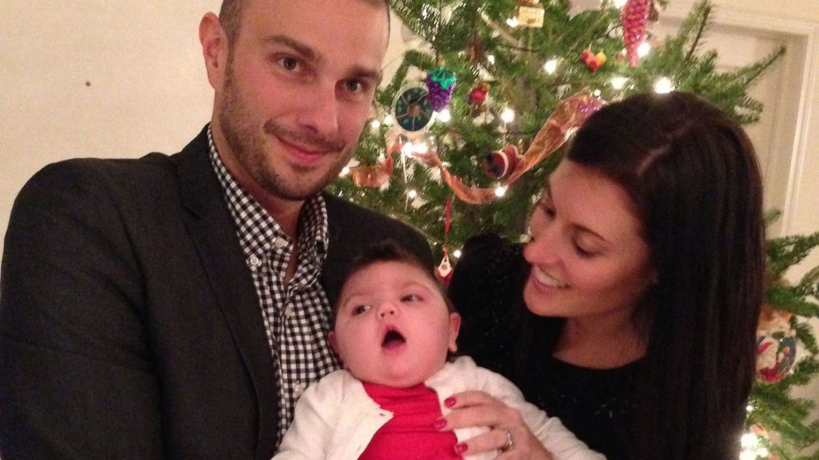 PHOTO: John and Kristen Spytek pose with their daughter Evelyn, who died in 2014.