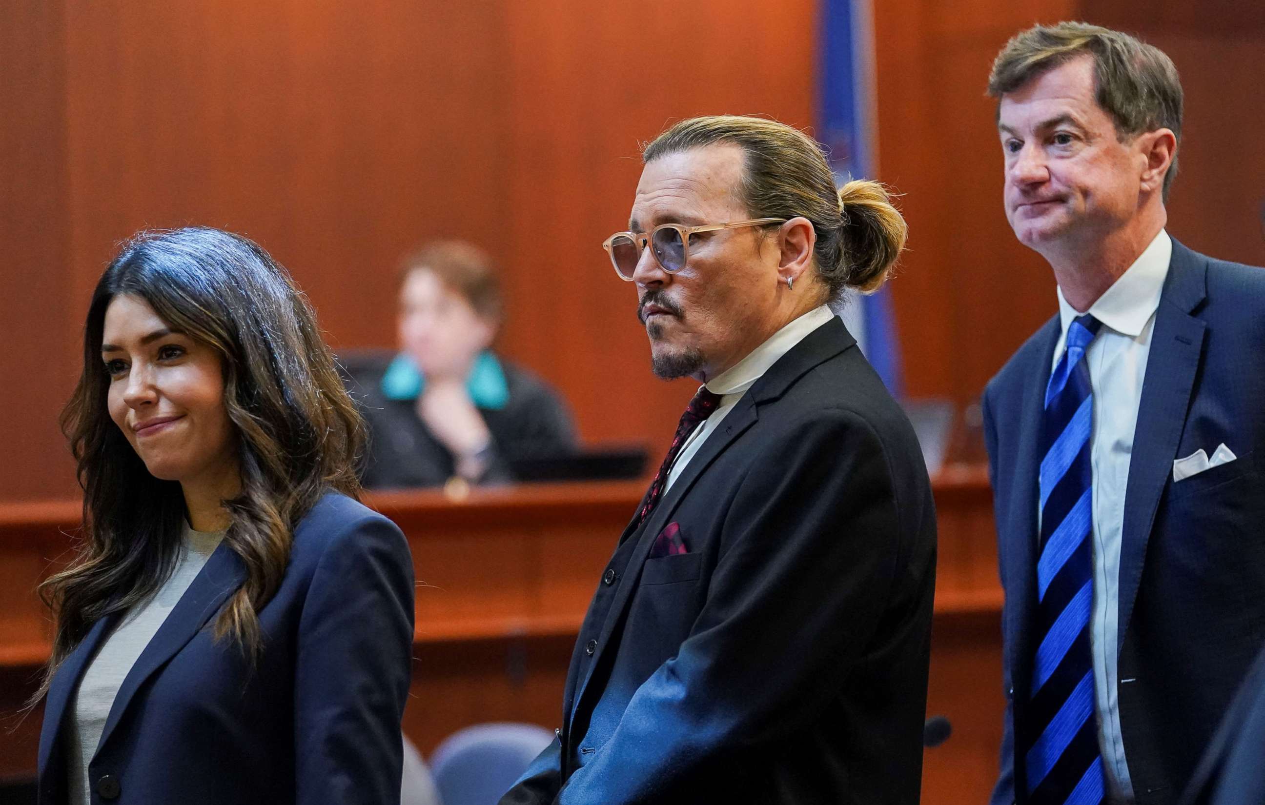 PHOTO: Actor Johnny Depp stands next to his lawyers, Camille Vasquez and Ben Chew, after a break in the defamation trial against ex-wife Amber Heard at the Fairfax County Circuit Courthouse in Fairfax, Va., on May 18, 2022.