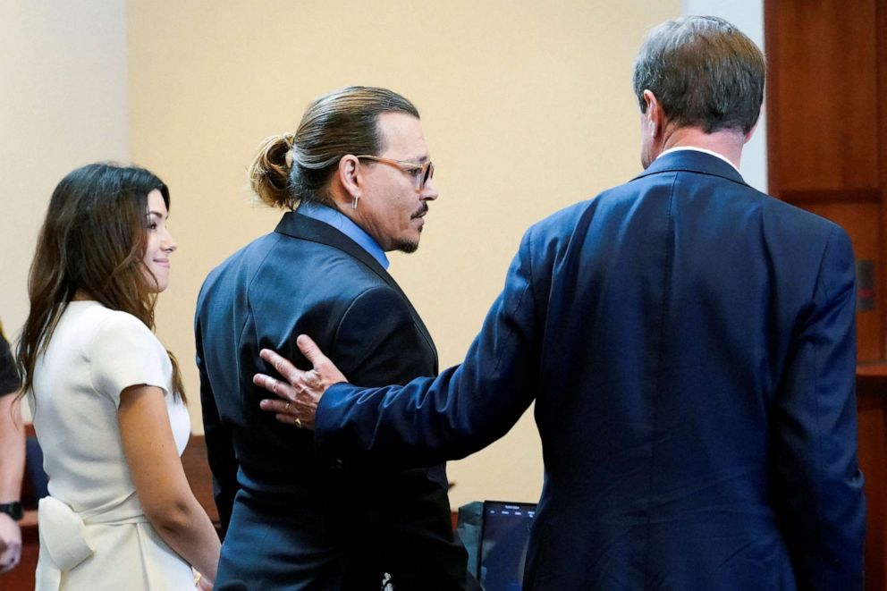 PHOTO: Actor Johnny Depp stands with his legal team Camille Vasquez, and Benjamin Chew in the courtroom during Depp's defamation case against ex-wife Amber Heard at the Fairfax County Circuit Courthouse in Fairfax, Va., May 27, 2022.