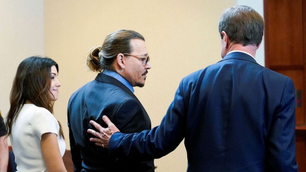PHOTO: Actor Johnny Depp stands with his legal team Camille Vasquez, and Benjamin Chew in the courtroom during Depp's defamation case against ex-wife Amber Heard at the Fairfax County Circuit Courthouse in Fairfax, Va., May 27, 2022.