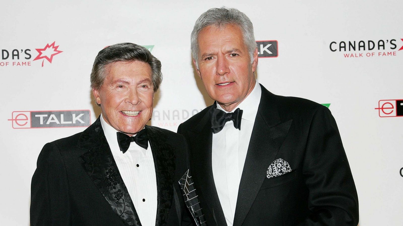 PHOTO: Presenter Johnny Gilbert and honoree Alex Trebek attend Canada's Walk Of Fame Gala at the HummingBird Centre June 3, 2006 in Toronto.